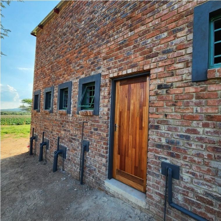 Face brick outside wall with a solid timber door