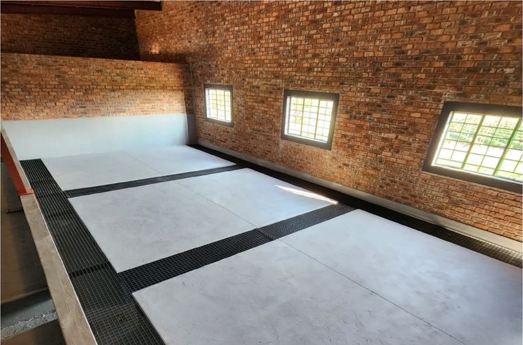 Floor bays laid with drainage channels between them