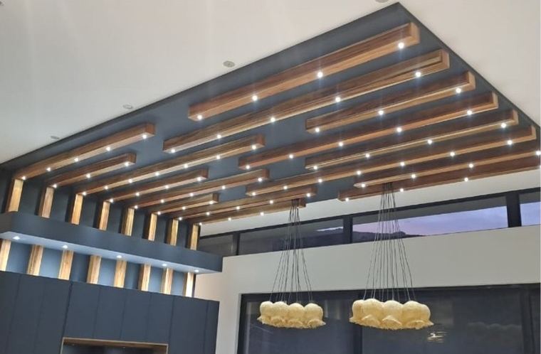 Timber batten ceiling lit between the beams