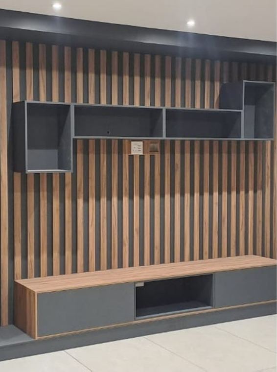 Slatted timber wall with a built in cabinet and a floating bench